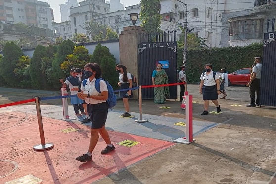 Senior students of Sushila Birla Girls’ School enter the campus maintaining social distance. Principal Koeli Dey was at the gate to ensure that students followed COVID-safety practices. 