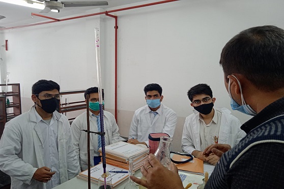 Masked Class XII students of Apeejay School, Park Street attend laboratory sessions in small groups with their instructor. 