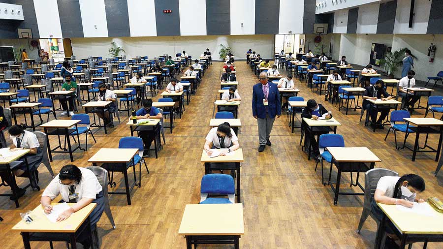 Students of South City International School write a mock exam on the campus on Wednesday.