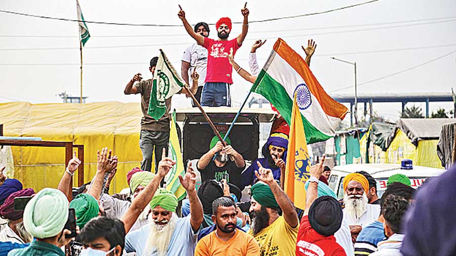 Farmers dance as they celebrate after Prime Minister Narendra Modi announced the repealing of the three farm reform laws, at Tikri Border in New Delhi, Friday, Nov. 19, 2021.
