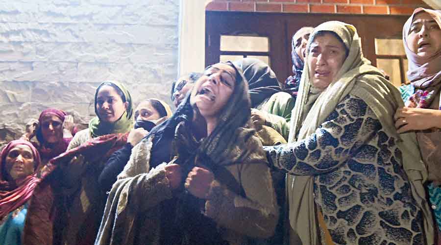 Griefing relatives of Mohammad Altaf Bhat athis  funeral procession at Barzulla in Srinagar on Friday. 