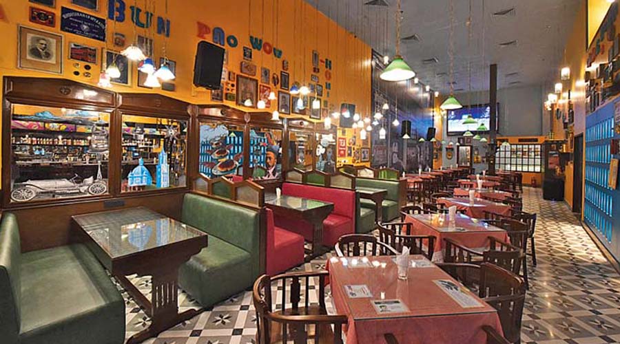 Just like a page out of an Irani Cafe, the outlet has minimal seating layout — think wooden tables and chairs with chequered and laced tablecloth, and red and green leather sofas. The patterned floor tiles add to the yesteryear vibe of the place. Some of the tables have cutting chai glasses inside sealed with a glass top and some have fun Parsi-Irani fun facts.