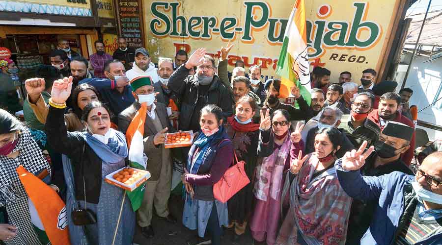 Congress workers celebrate the Centre’s decision to withdraw the three farm laws in Shimla on Saturday.