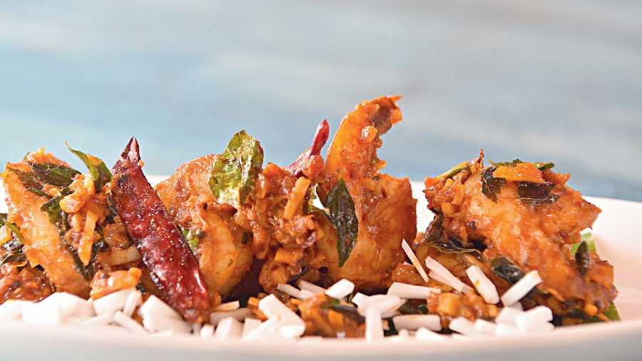 Kerala Fried prawns flavoured with curry leaves is a slightly spicy dish made with Indian spices and served with julienned coconut that prawn lovers will relish with their drink. Rs 299