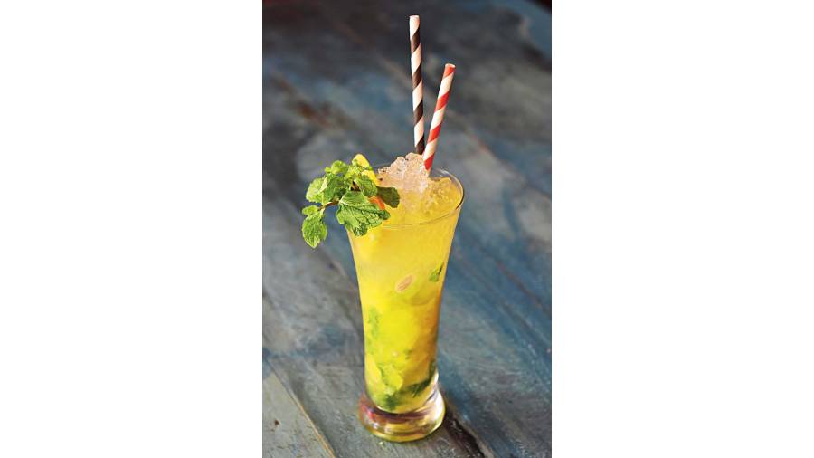 The orange mojito mocktail is prepared with orange juice, soda, mint syrup, crushed ice and lime chunks. Rs 200