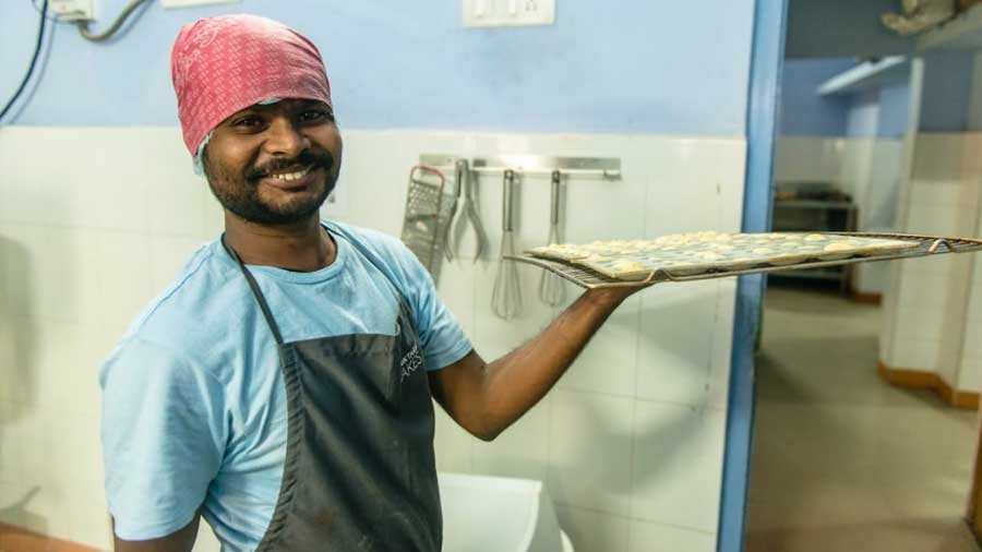 Sanjay Sarkar putting madeleines in the oven