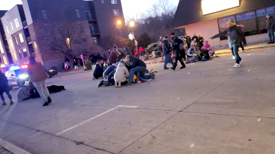 Passersby attend to injured people after the massacre, in Wisconsin on Sunday.