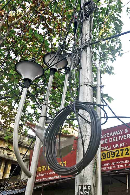 Overhead cables hang on a lamp post on  Harish Mukherjee Road last week.