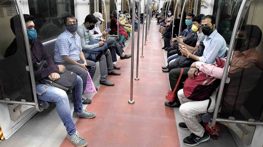 Passengers with masks inside a metro in Calcutta