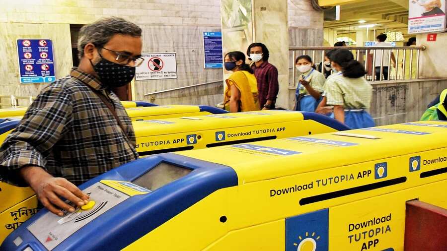 A passenger uses a token to gain entry to the platform at Belgachhia Metro station. Token turnstiles buzzed back to life after a long gap of 21 months. 