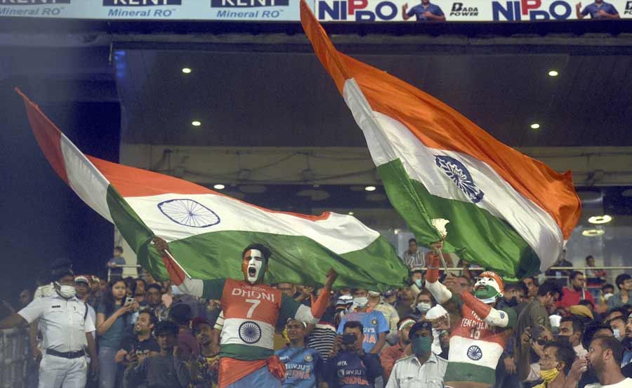 GOOD LUCK CHARM: Two cheerleaders wave the Tricolour at the India-New Zealand match at Eden Gardens on Sunday, November 23. India thrashed New Zealand by 73 runs in the third and final T20I to win the three-match series