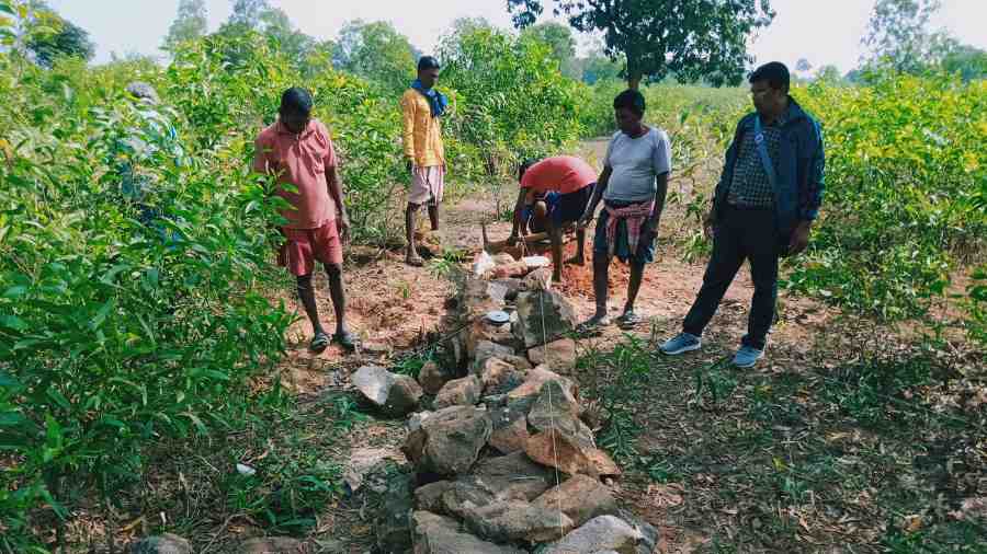 Villagers help construct a reservoir 