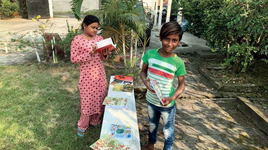 Children browse through books at a reading session