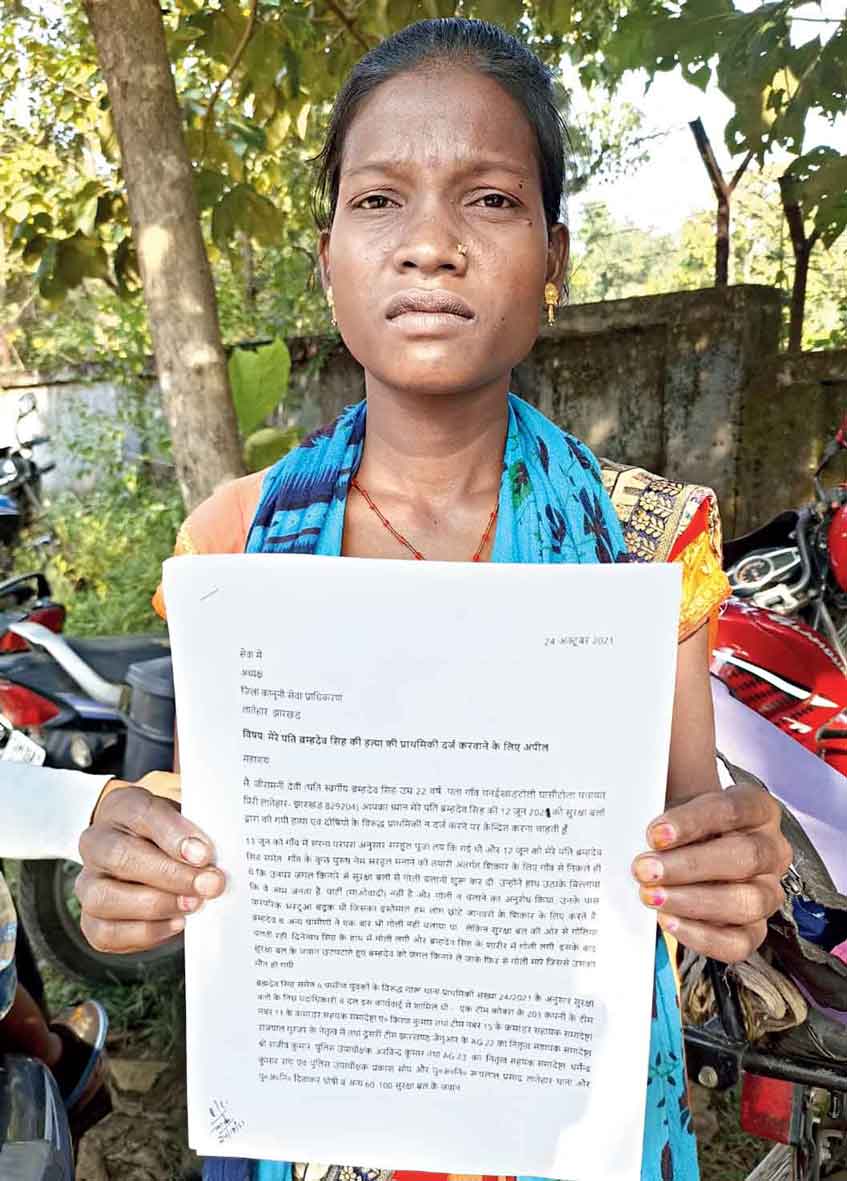Jiramani Devi with the application in front of the Garu police station in Latehar in June.