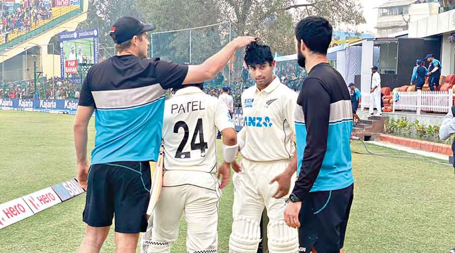 Teammates applaud Rachin Ravindra whose unbeaten, gritty innings helped New Zealand draw the first Test at Kanpur on Monday.