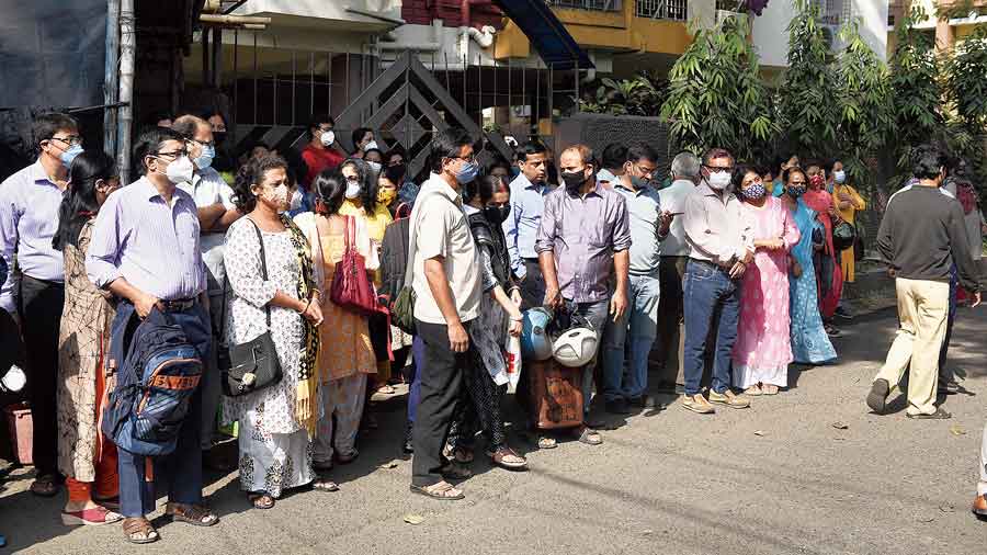 Parents of students writing ICSE wait outside Rammohan Mission High School on Monday.
