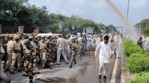 Police use water cannons to disperse farmers in Jhajar on Friday.