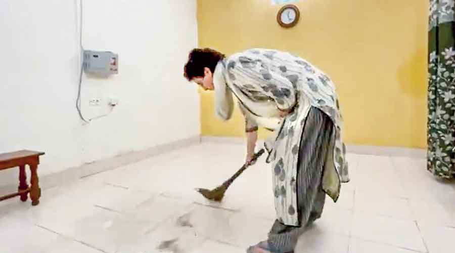 Priyanka Gandhi sweeps the floor of a guest house in Sitapur where she is being detained.