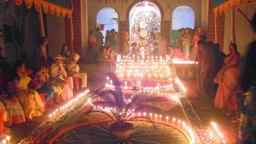 In this picture from a previous year, the courtyard of the house is lit up for Sandhi Puja 