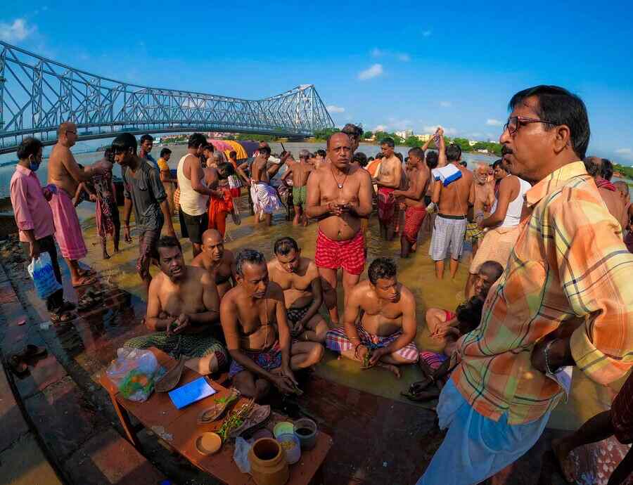 Tarpan -- prayers for forefathers -- at Jagannath Ghat in north Kolkata on Wednesday morning. Mahalaya heralds the end of 'pitripokkho' and the beginning of Ma Durga's journey to her parents'  home