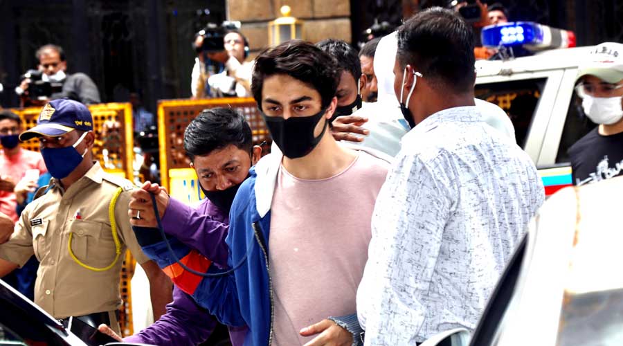 Aryan Khan, arrested in drugs case, being escorted at the NCB office after a medical check-up, in Mumbai