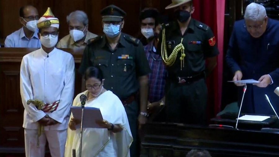 Governor Jagdeep Dhankar administers oath of office to Mamata Banerjee on Thursday.