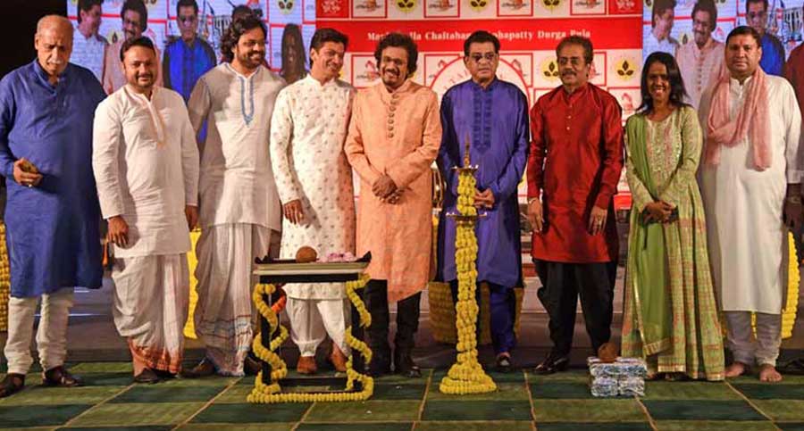 Lighting of the lamp by (L to R) Manicktalla Chaltabagan Lohapatty Durga Puja Committee president Ashok Jaiswal, musician duo Sourendro-Soumyajit, Shaan, Bickram Ghosh, Amit Kumar, Hariharan, Mahalakshmi Iyer and Committee chairman Sundeep Bhutoria. 