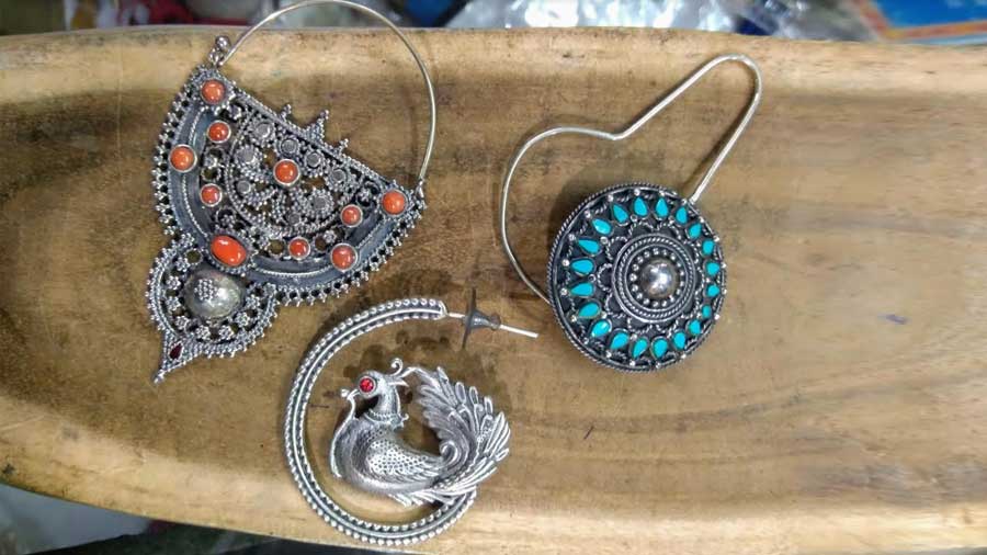 Make a style statement in silver with these large earrings from Chamba Lama. Studded with gemstones in turquoise, burnt orange and crimson to match your  festive wear. Prices range between Rs 1,000 and Rs 2,500.