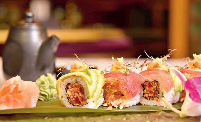 Crunchy Tuna Roll is a must-try for any sushi lover. Little modified, this one has tuna roll stuffed with chunks of tuna and tanuki wrapped with avocado and thin tuna slices with tobanjan aioli on top.