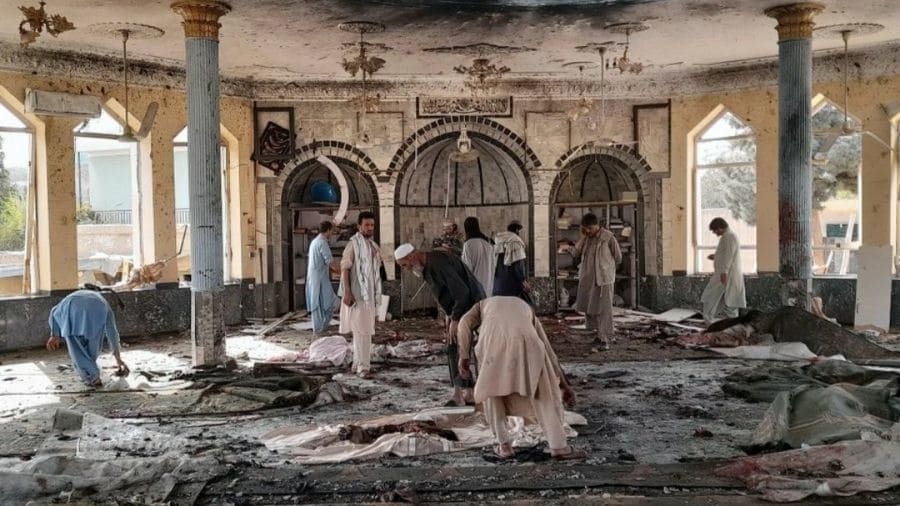 People view the damage inside the mosque after the bombing in Kunduz, northern Afghanistan, on Friday. 