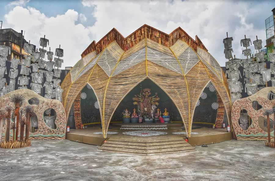 A surprise greeted pandal hoppers at Kashi Bose Lane Durga Puja, which has focussed on the imbalance in life, instead of symmetry. The pandal has a pointed polygon at the top, instead of a traditional curved dome. The pandal also has shirts with illustrations depicting lives lost in the pandemic.