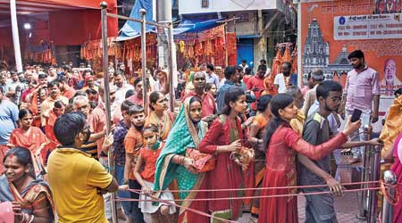 Devotees wait to offer prayers at the  Patan Devi temple in Patna on Sunday during Navratri festival. 