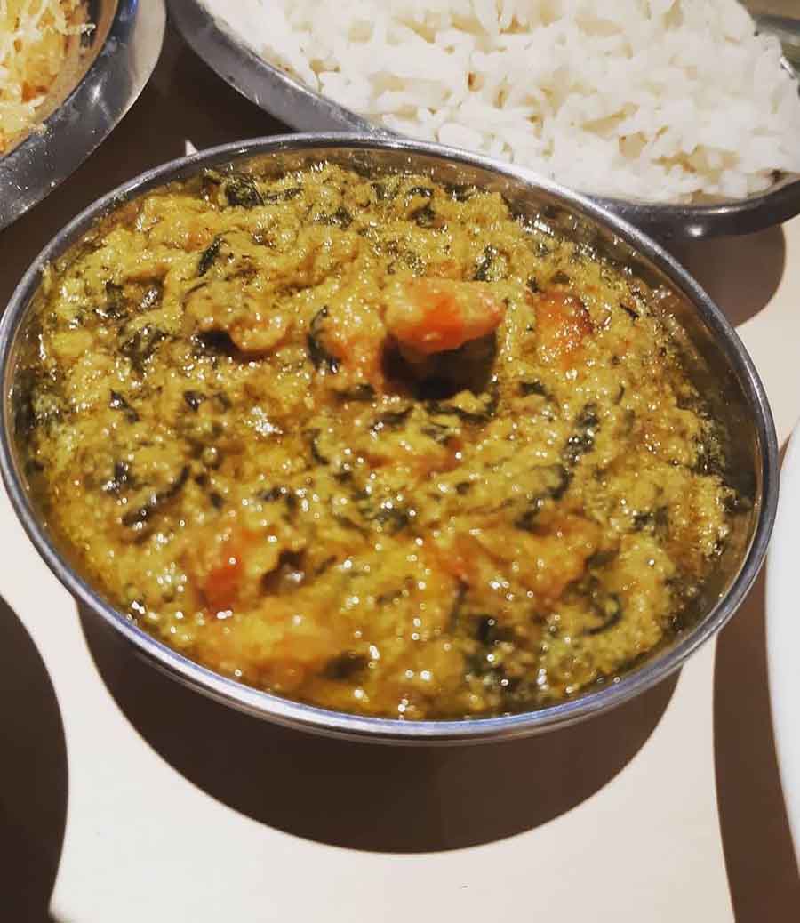 KOCHUPATTA DIYE CHINGRI BHAPA FROM KASTURI: This famous mustard-infused dish is more about the greens (colocasia leaves) than the shrimps. Indulge once more in this speciality at the New Market, Ballygunge and Dover Lane outlets. Lathered in mustard oil, it is best combined with steamed rice.