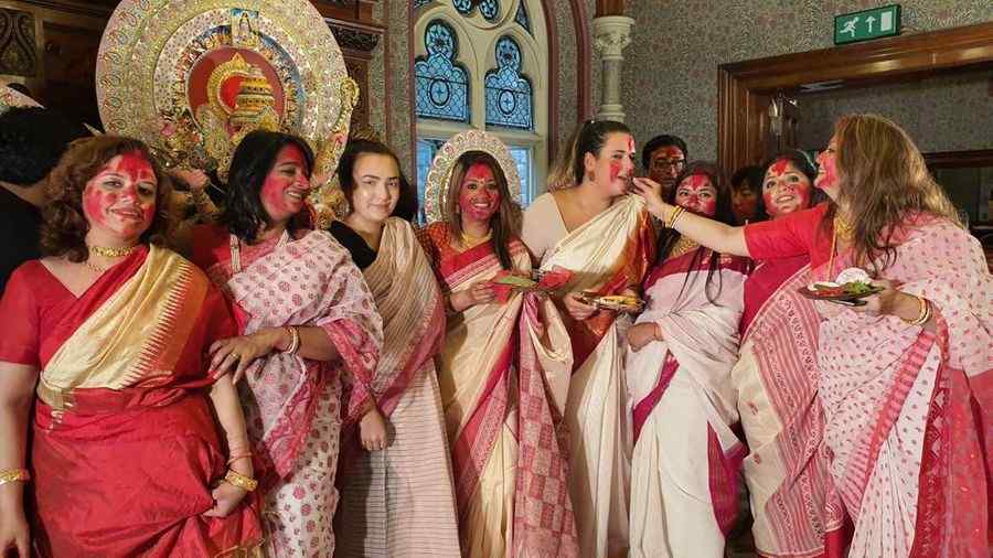 Women participate in 'Sindoor khela' during the 2019 puja