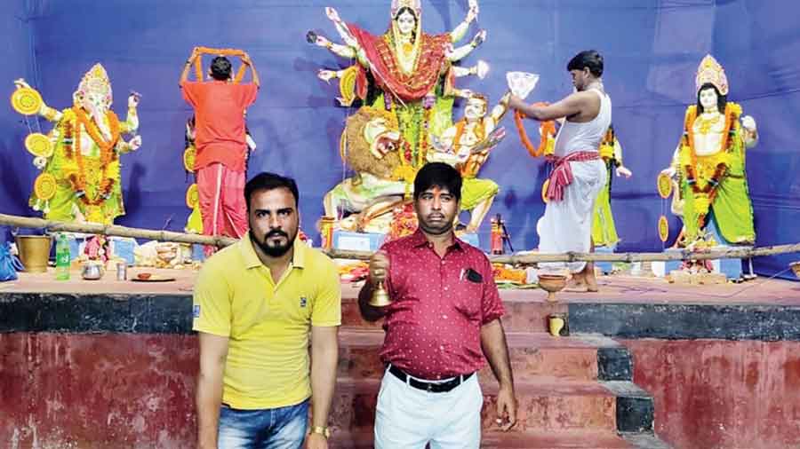 Puja committee secretary Mohammed Raja Ansari beats the dhaak and president Birju Prasad Lal rings the bell at the Mominpara pandal on Thursday. 