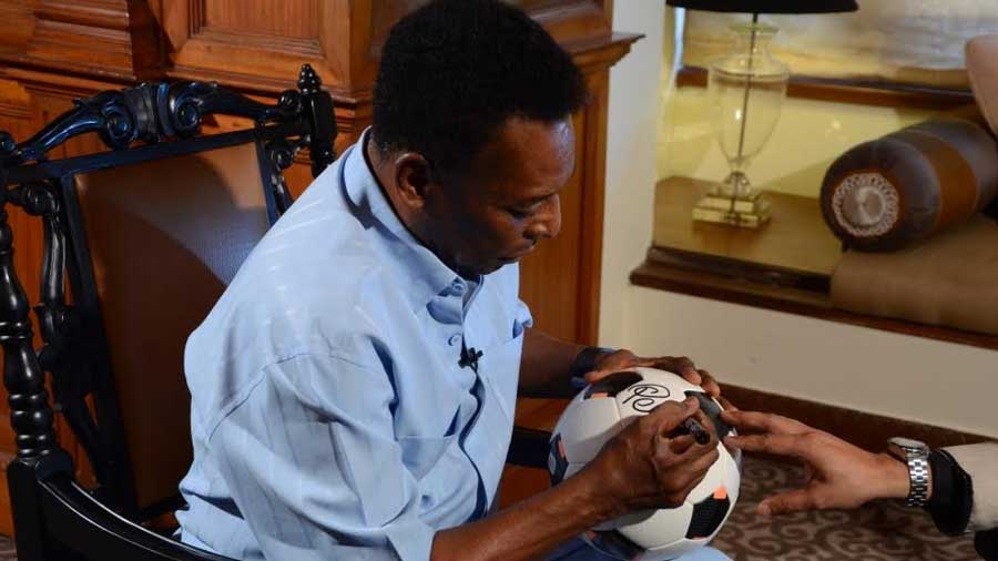 The legend autographs a football