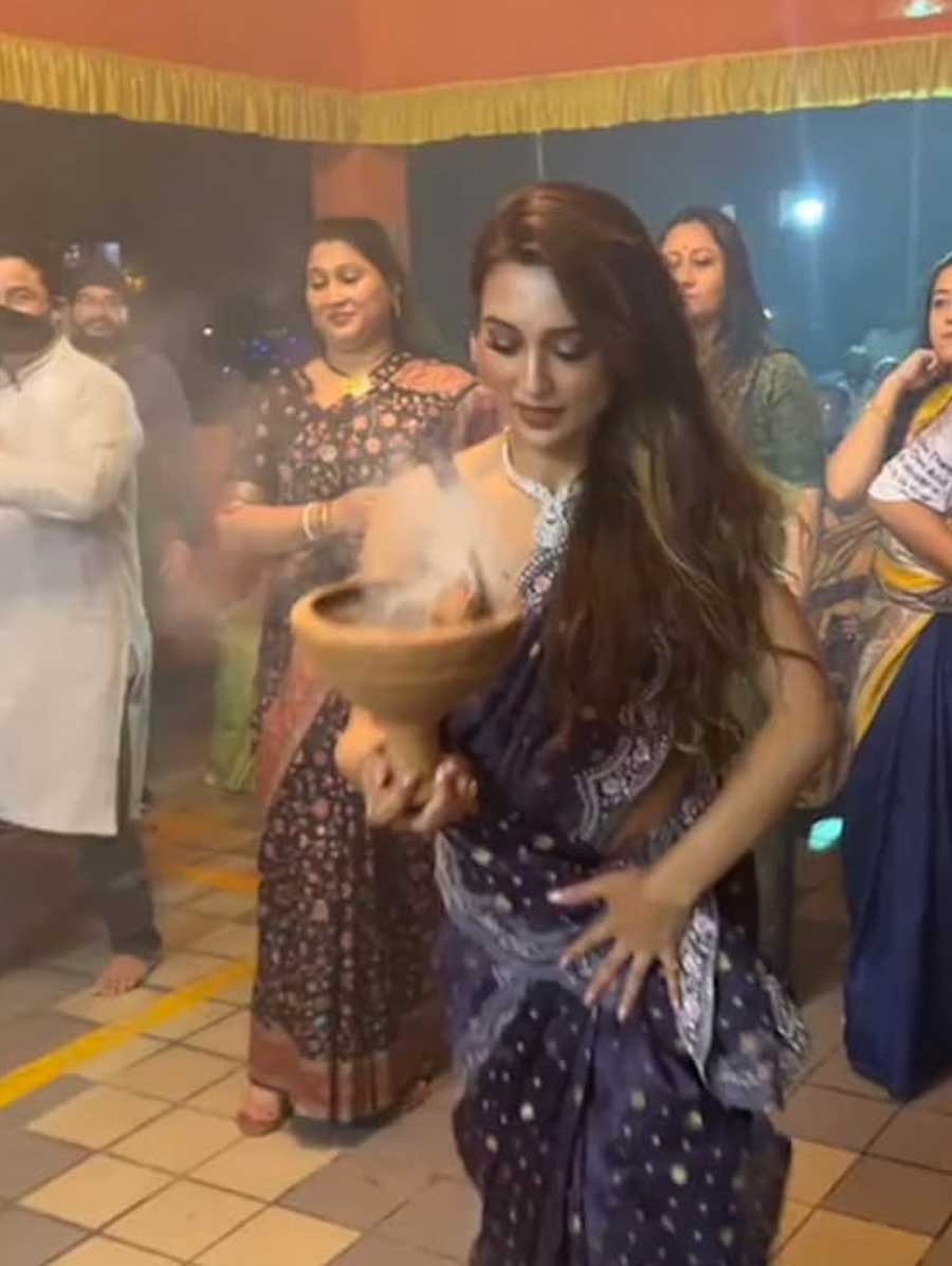 DIVINE GROOVE: Actor turned politician Mimi Chakraborty shows off her dhunuchi moves on Friday, October 14. She posted a video on her Instagram page in which she was seen deftly handling the dhunuchi with one hand and keeping her sari out of the fire's way with another