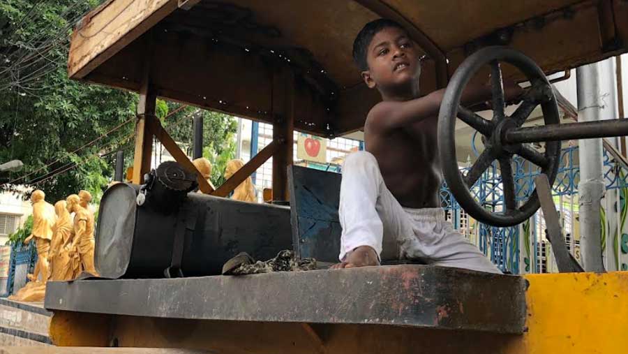 Five-year-old Aidul on the road roller