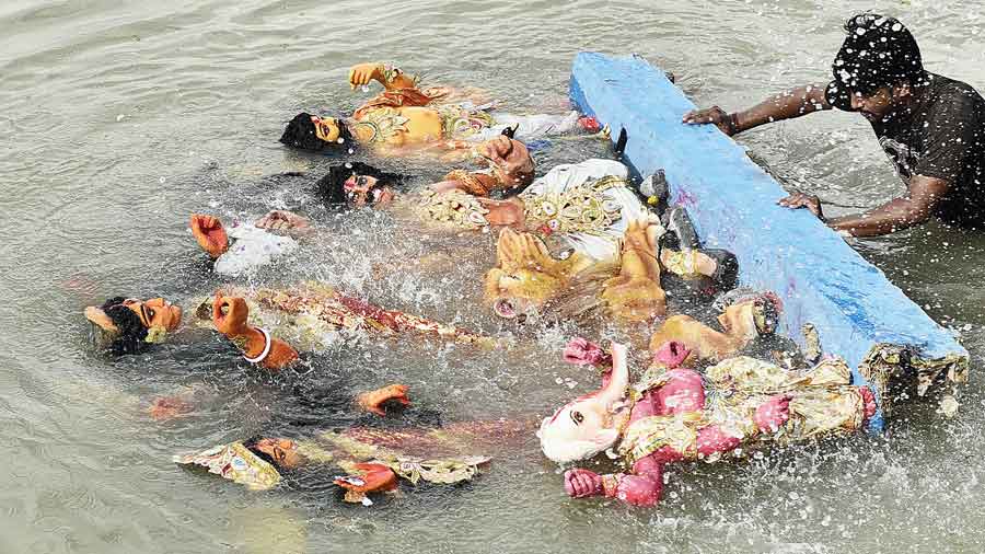 Idols being immersed at Judges Ghat on Saturday. 