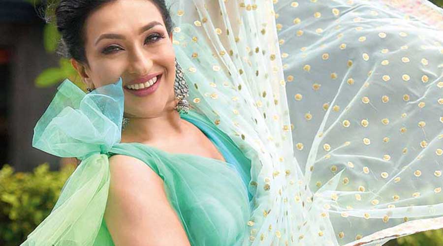 Rituparna looked carefree cool in this sea green sari. “I found the blouse to be really interesting. It’s giving the look a sassy lift. With the sequinned sari, it is a beautiful fusion. It has got a little bit of traditional touch on the borders. The chunky jewellery adds to the look. This is a sophisticated look. The colour is fresh and beautiful. The hair is neat and elegant,” said Rituparna. Hair and make-up pro Kaushik had daytime functions in mind. “ I have used peach, coral and mauve-ish pink, all matte. The primer was used to tighten the pores. It also makes the skin glow and you need just a bit of base. I have used a light foundation and dusted it with compact powder. Lips are beige pink and the hair a messy puffed-up ponytail,” he said. Stylist Rajat picked a “different” kind of blouse. “Green is in. So, I chose a sea green sari,” he said. The silver earrings complemented the look.