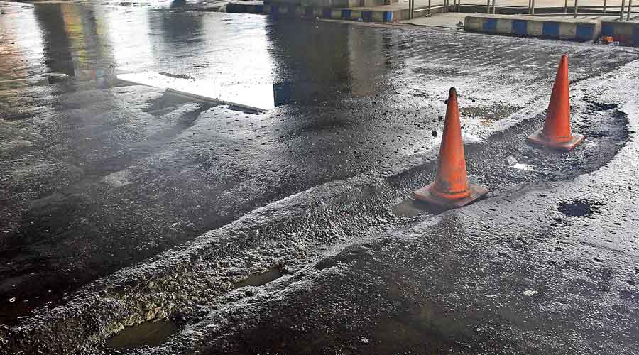 Traffic cones placed on the road below Karunamoyee Metro station, near the Karunamoyee intersection.