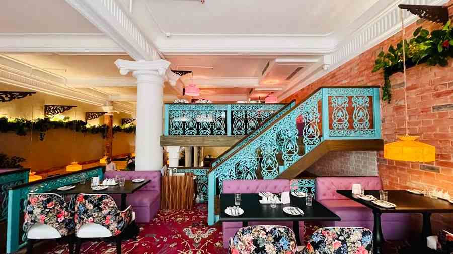 The vibrant interiors of the 145-seater restaurant with botanical prints and shades of pink, violet and teal.