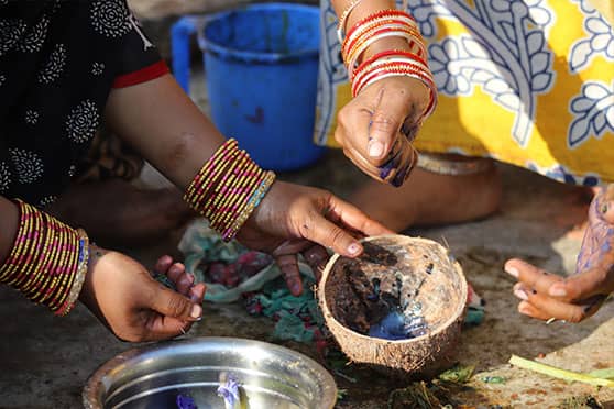 Women patachitrakars making the colour blue, extracted from the Aparajita flower. 