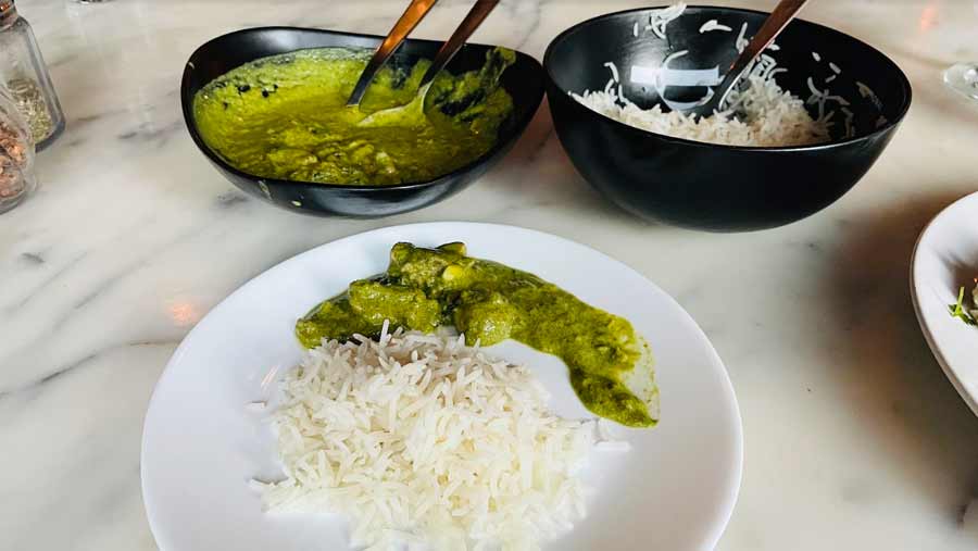 Thai Green Curry served with a side of white rice 
