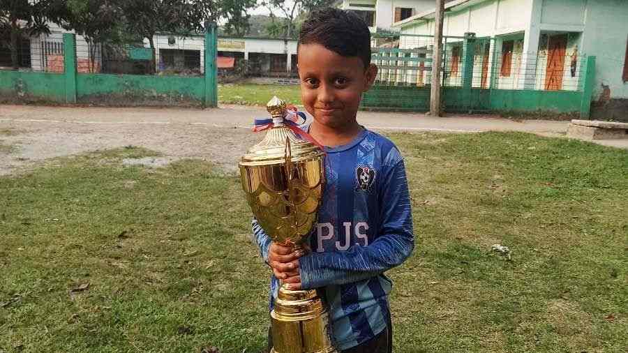 Sadid posing with one of the many trophies he has already won at his tender age