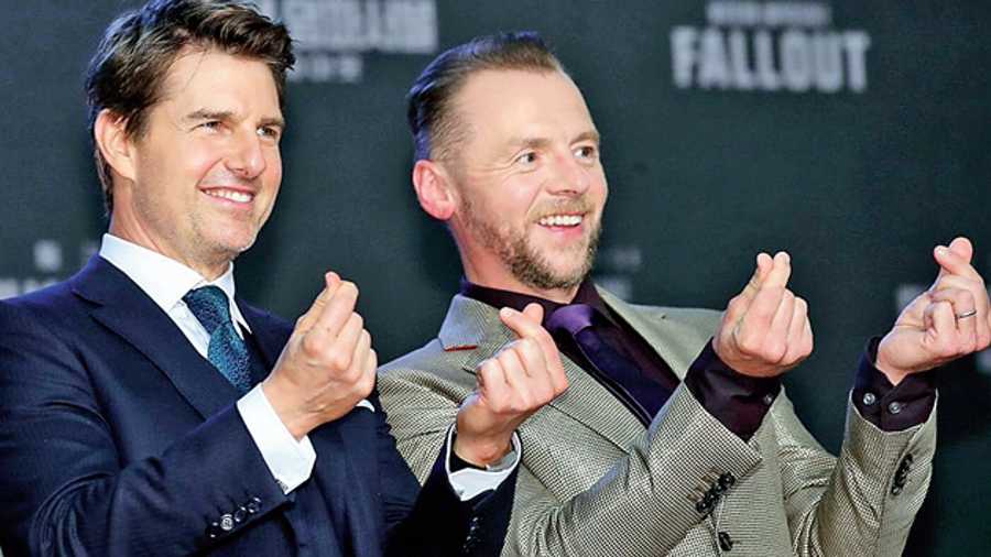 File picture of Tom Cruise and Simon Pegg displaying finger hearts, an integral part of K-culture