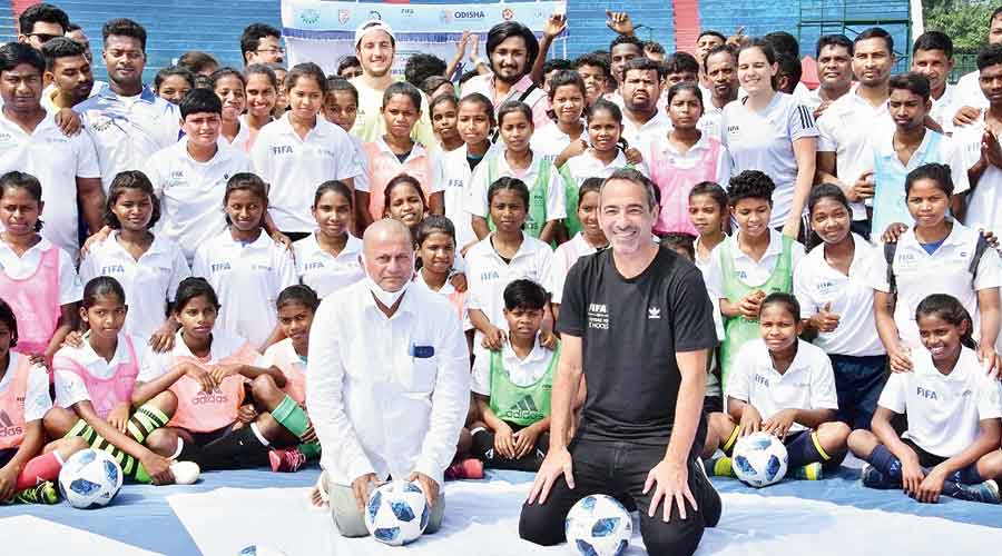 Achyuta Samanta, Youri Djorkaeff and budding football players during the launch of the Fifa Football for Schools programme in the KIIT campus in Bhubaneswar on Wednesday 