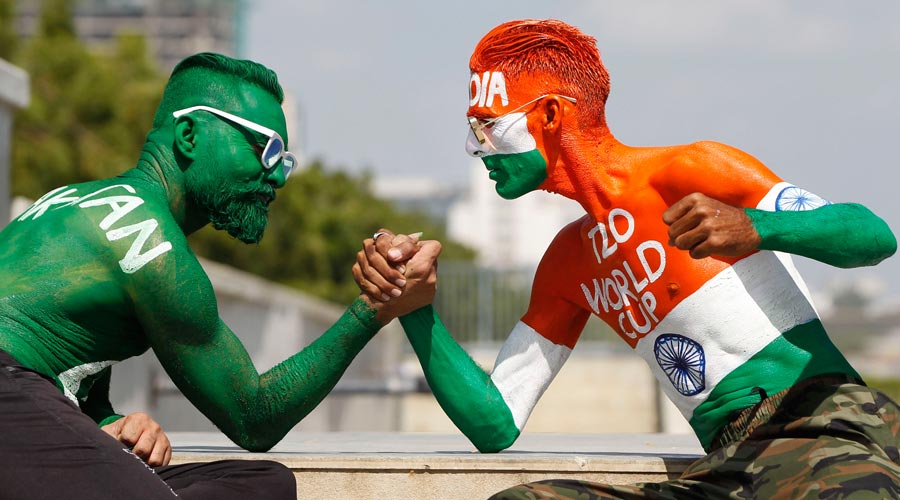 A man named Arun Haryani painted his body with Indian Tri-color and Anil Ladvani painted Pakistan national flag on his body pose ahead of India-Pakistan T20 world Cup match, at Sabarmati Riverfront in Ahmedabad, Saturday, Oct. 23, 2021.