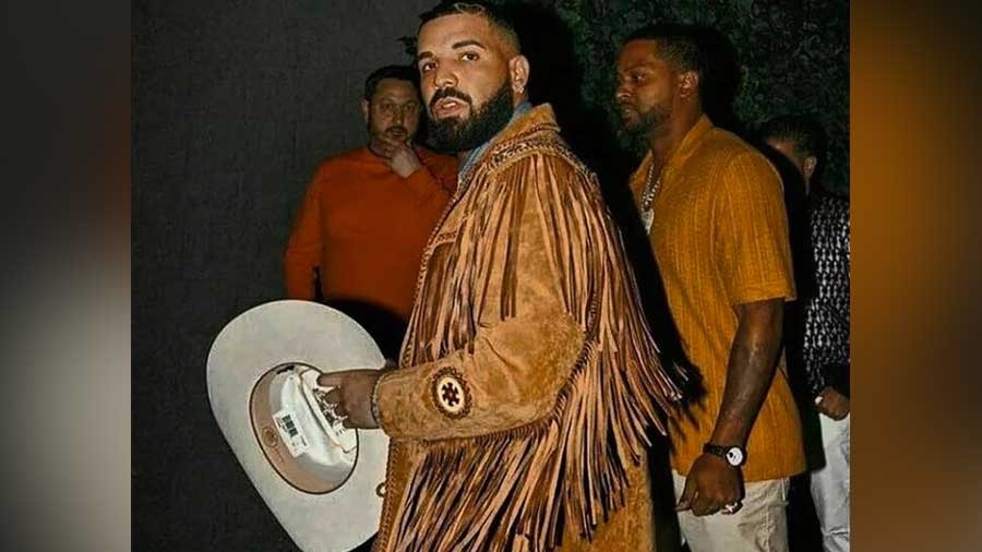 Drake's Wild West ensemble featured a washed denim shirt, tan fringed jacket and cowboy hat