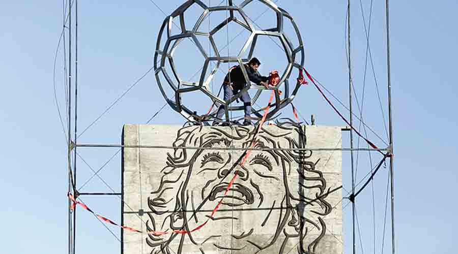 A worker adds the final details to a new monument honouring the late Diego Maradona in Santa Clara del Mar, Argentina, on  Friday. 